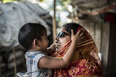 Jahanara Begum (35) plays with her son, Sabbir, at her home in Narsingdhi. Both Begum and her husband, Jashim Uddim, have been blind since childhood.