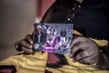 Fatima Mohamed Hussein (52) displays a photograph of her nephew Bakar Hussein taken on his wedding day. Bakar died at sea the age of 33 in December 2016, leaving behind five children. He was a boat ca...