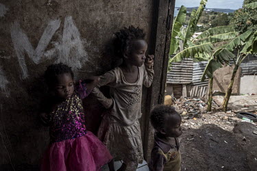 Undocumented Comorian migrant children look out from their 'banga' (a shack made with corrugated zinc sheets) in the slum of Kaweni, thought to be the largest slum in France.