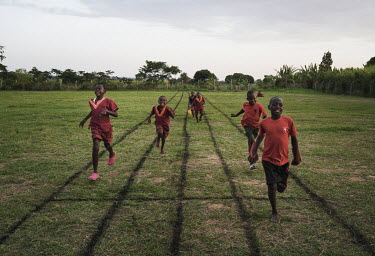 Students running on the playing field during the school break.