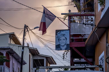 A tricolour flag and a poster of Marine le Pen hang outside a home in Mamoudzou,. Despite it's overwhelmingly black and Muslim population, Le Pen is revered here due to her stance on immigration.