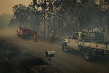 Volunteers from the New South Wales (NSW) Rural Fire Service (RFS) attend to an out of control fire as weather conditions in New South Wales (NSW) have made circumstances ideal to spread catastrophic...