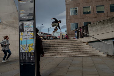 A skateboarder jumps a flight of stairs at London Bridge.