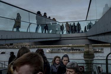 People crossing the Millennium Bridge in central London.