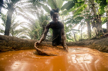 A woman processing palm oil.