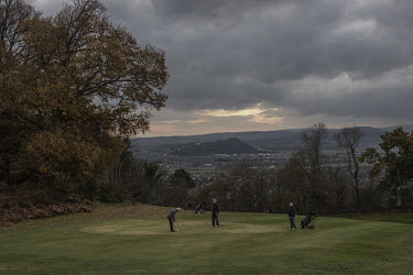 Women play golf at tehe Bridge of Allan golf course with Stirling castle, the seat of kings after Independence from England in 1314, looming in the background.