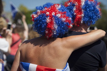 A couple wearing Union Jack wigs stand among the crowds gathered in Windsor on the morning of the 19 May 2018 for the Royal Wedding between Prince Harry and Megan Markle.