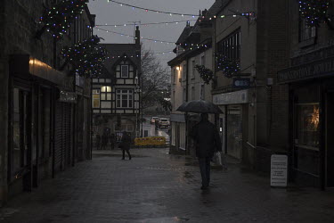 People walk through the rain in the town of Bolsover.