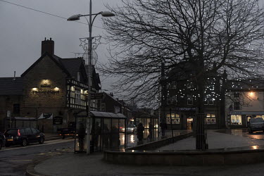 People shelter in bus stops as the rain falls in the town of Bolsover.