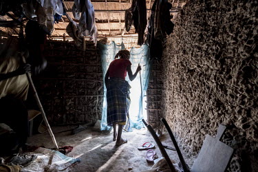 Sahura Mussa (63) and her husband Gordane (70), both of whom have been blind for several years due to untreated cataracts, using bamboo sticks to help them move around in their home.