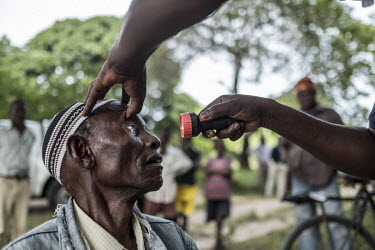 Jareya Silva (87) has his eyes examined at an eye screening camp.