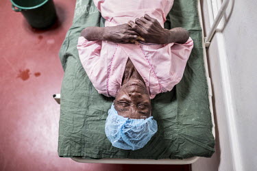 Sahura Mussa lies on a trolly as she waits to be anaesthetised by nurse Madina Daniel Camila ahead of her cataract surgery at the Nampula Hospital.