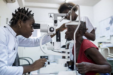 Ophthamologist Cornelia Denise Jorge Chilundo Toure (37) examines Sahura Mussa's eyes with an ophthalmoscope on the morning after her cataract operation at the Nampula hospital.