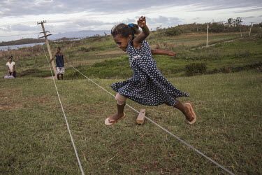 Salome (6) skipping over high voltage wires in the Veicorocoro Settlement. After Cyclone Winston hit Fiji in February 2016, there was no power for many weeks in affected areas.