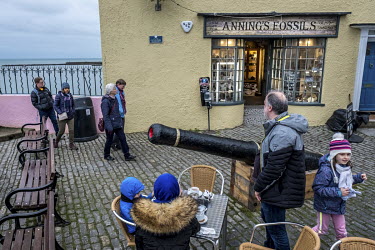 People walk past a fossil and curio shop owned by collector Barry Titchener. The shop was used as the setting for Mary Anning's fossil business on the set of the upcoming biopic about the Lyme Regis-b...
