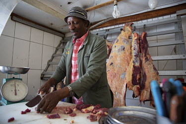 Makonen Abiyo, the butcher at the Bersufekad Ethiopian restaurant, cutting up meat for the dishes they sell from premises on Rockey Street in the Johannesburg suburb of Yeoville.
