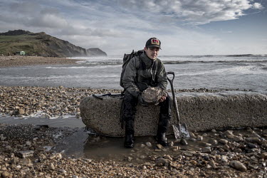 Fossil hunter Kameran Sabbaghi, from Southampton, on Charmouth Beach with an ammonite, still partly encased in limestone, that he found while hunting for fossils on the beach. Sabbaghi hopes to one da...