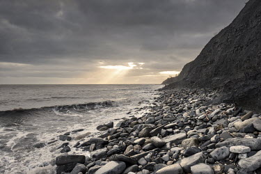 The sun set over Monmouth Beach, a world-famous fossil collecting site in the heart of England's Jurrassic Coast, where soft cliffs are constantly eroding, leaving new fossils exposed every day.