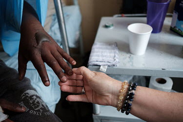 Snake and snakebite expert, Thea Litschka-Koen, examining the hand of Qiniso Sihlonganyane (36) at the RFM Hospital. Sihlonganyane had been bitten on the hand by a Mozambique spitting cobra while asle...