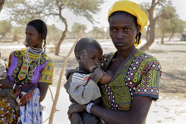 A Fulani woman breast feeeding her child. She is partof a group who fled their village of Woulpho Halpha and headed towards Gibo after being threatened by jihadists who gave them three days to leave t...
