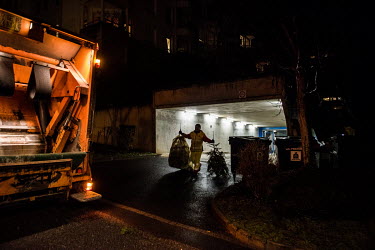 Collection of Christmas trees by a dedicated rubbish truck, searching the streets of the streets of Geneva for discarded trees. The trees are compacted in the truck and transferred to a site for burni...
