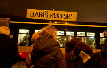 A woman carries a sing that reads: 'Babis Rubbish' during a protest demanding the resignation of PM Andrej Babis.