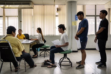 Drivers take the physical part of their driving exam where their reactions are recorded as they press foot peddles during assessment at a test centre.