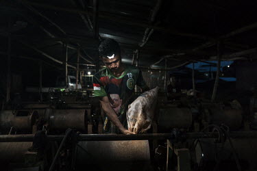 A worker at a ball mill empties a sack of crushed ore, extracted from small-scale artisanal gold mines on the Indotan concession, into drums where it is mixed with water and mercury and spun for sever...
