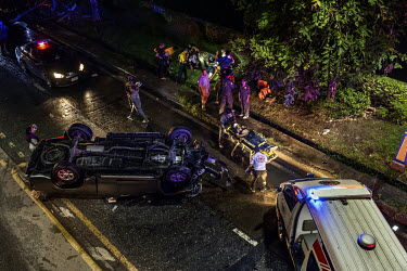 Paramedics treat five injured people who were travelling in a pickup truck that hit a lamp post and flipped over. The paramedics said the driver and passengers were drunk.