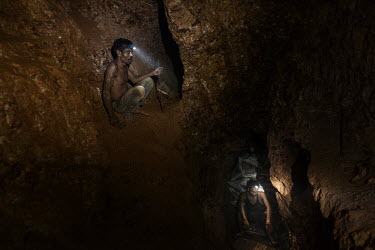 Miners dig ore in a small-scale artisanal gold mine on the Indotan concession.