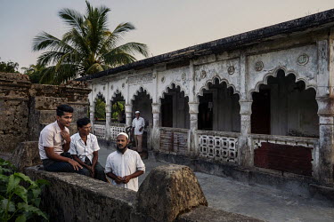 Ethnic Rohingya Muslims gather before prayer at one of the few undamaged mosques in Northern Rakhine.