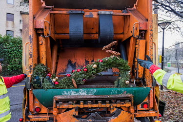 Trees are compressed during a collection of Christmas trees by a dedicated rubbish truck which searches the streets of Geneva for discarded trees. The trees are compacted in the truck and transferred...