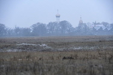 Churches towers rises above the town of Turau, viewed from the frozen Turau meadowlands, an RPB (Belarus Birdland managed reserve).