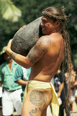 A man takes part in a stone lifting event (amora'a ofai) at the Feast of Heiva which brings together all the traditional arts and sports of Polynesia.