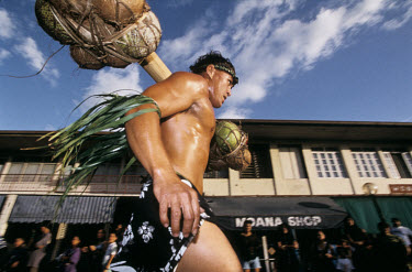 A man takes part in a traditional sportig event during the Feast of Heiva which brings together all the traditional arts and sports of Polynesia.