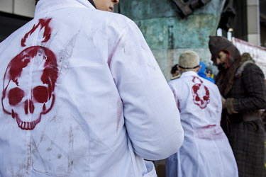 Demonstrators wearing white lab coats marked with a burning skull symbol during a protest outside the International Maritime Organisation (IMO) against the use and carriage of Heavy Fuel Oil (HFO) by...
