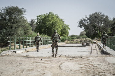 Soldiers from the Multinational Joint Task Force (MNJTF) against Boko Haram patrolling on the Douji Bridge which crosses the Komadougou Yobe River, the border between Niger and Nigeria.