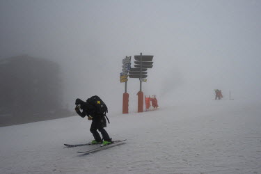 An employee skis during a storm at the ski resort of Avoriaz. Despite being less exposed than many other resorts to a lack of snow, nearly 50% of snow on this high altitude resort depends on making sn...