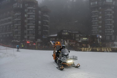 An employee on a snowmobile during a storm at the ski resort of Avoriaz. Despite being less exposed than many other resorts to a lack of snow, nearly 50% of snow on this high altitude resort depends o...