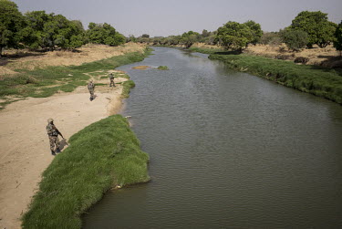 Soldiers from the Multinational Joint Task Force (MNJTF) against Boko Haram patrolling the Komadougou Yobe River, the border between Niger and Nigeria.