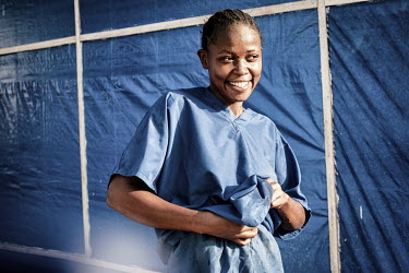 A nurse smiles after leaving the high-risk area of the Nzerekore ETC.