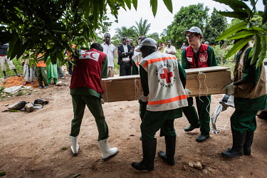 Members of the Guinean Red Cross conduct a safe burial near the home of Finda Marie Kamano (33) who died of Ebola virus just two days after she tested positive for Ebola at the Ebola Treatment Centre...