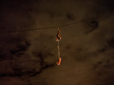 A pairs of training shoes dangling from a wire at an intersection, according to the police, this is a sign used by the gangs to show customers that drugs can be purchased at this spot.   Bonteheuwel n...