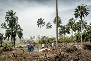 Staff at the Ebola Treatment Centre (CTE) wearing full personal protective equipment (PPE) conduct a safe burial for Odile Mory (20) who died after she became infected with the Ebola virus as a result...