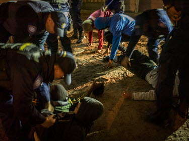 Police officers frisk a group of young men in Bonteheuwel.   Any young men standing in groups after dark are consistently stopped, thrown to the ground or off a wall and promptly body-searched. Most d...