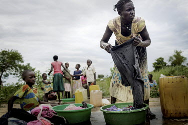 Angelina Monday (32) washing clothes by hand in the company of her children at the Bidibidi Refugee Settlement.  The family crossed the border from war-torn South Sudan in 2017 and like most incoming...