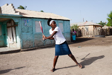 Elvira Pantaleon (18) prepares to strike a ball during a softball game in Batey No.1, near Tamayo. A 2013 ruling by the Dominican Constitutional Court made thousands stateless. It was particularly aim...