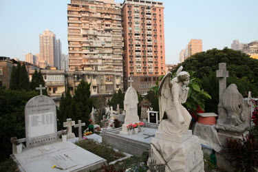A highrise building looms behind the tombs in St. Michael's Cemetery.
