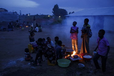 Angelina Monday (30) and her children and other relatives, newly arrived refugees fleeing conflict in South Sudan, cook a meal at a refugee shelter in the town of Kuluba. Here, refugees are given a ho...