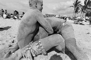 Two men wrestling on Playas del Este beach, which is where all of Havana comes to relax and bathe on the weekend.